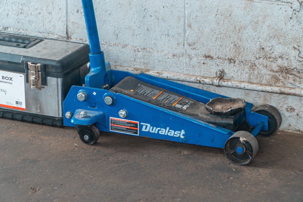 A heavy-duty floor jack in an auto shop.