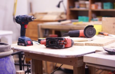 Power tools resting on a work table.